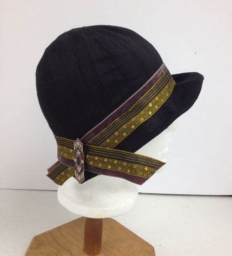 Where the two ribbon bands cross is an Art Deco brooch, that anchors the ribbons and gives interest to the back of the hat.