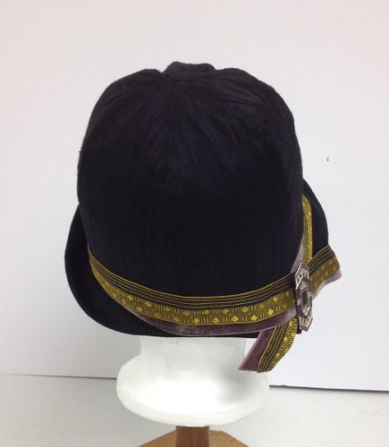 The brim of this hat is asymmetrical; turning up on the left front, swooping in a curve on the right back and forming a point at the left-side-back.