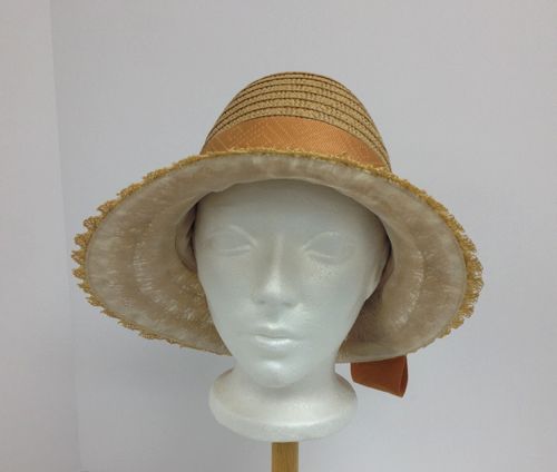 This 1924 cloche is a copy of an original vintage hat.  An existing straw was used for the crown and the brim is made from antique straw lace that has been faced with silk organza.