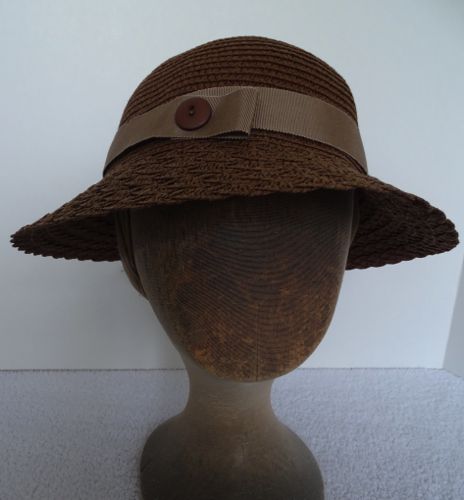 Front view of the brown straw cloche with braided straw brim.