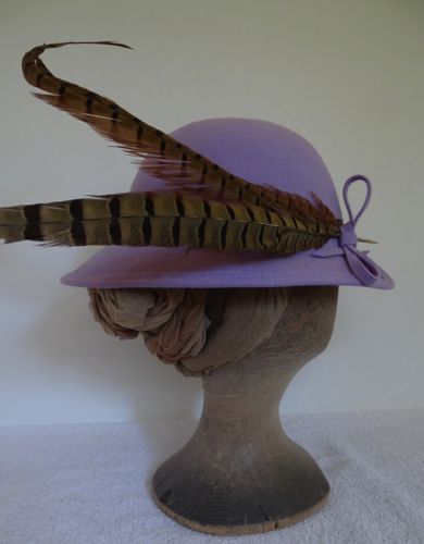 The pheasant feathers extend quite far from the hat in the back, giving the desired comical and extreme effect.