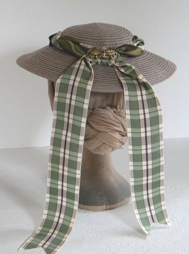 Green plaid ribbon forms the decorative trailing strings at the back.