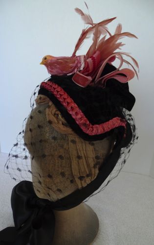 This 1885 bonnet started it's life as a 1950's cocktail hat!  It is made of a buckram frame covered with black velvet that has been knotted at the top to give some height.