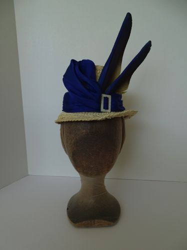 Made in 2018 this pale yellow straw hat is decorated with Macaw feathers in a striking natural shade of blue.