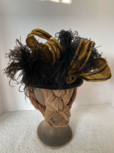 Gold silk duppioni loops were formed with fine wire hidden under narrow black satin ribbons.