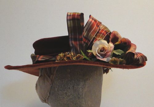 Trimmed with plaid taffeta ribbon and soft pink roses.