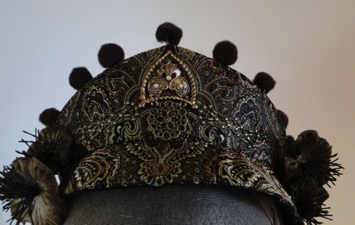 Detail of metal decoration on brown paisley diadem.