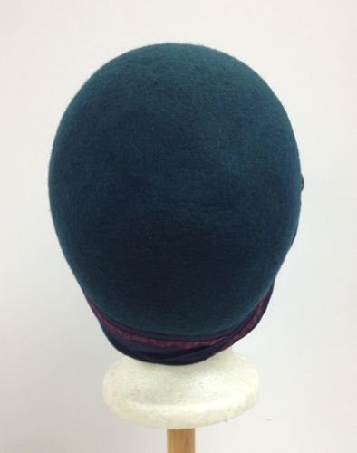 The felt was blocked to the cloche shape while it was still wet from the dye bath.
