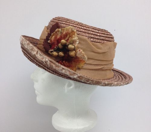 The left front of the hat is trimmed with vintage velvet leaves and fabric berries that have been stuffed with cotton.