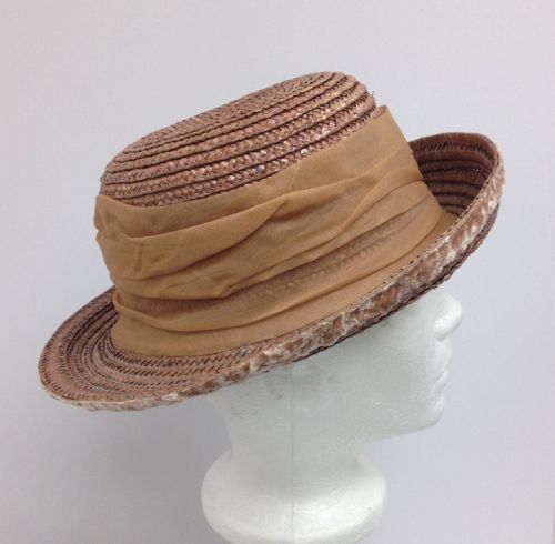 Made in 2017 for the TV series Damnation, this pink straw hat has a pleated band of silk chiffon cut on the bias.