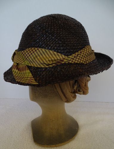 The hat band is made of a plaid silk taffeta cut on the bias.