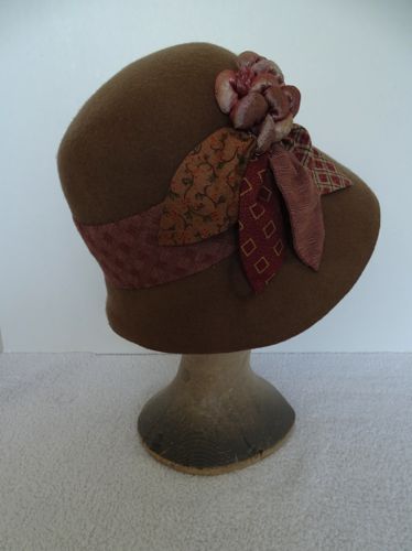 To hide unsightly glue residue a wide hat band and large petals were made from scraps of calico.  Vintage cloth grapes were added.