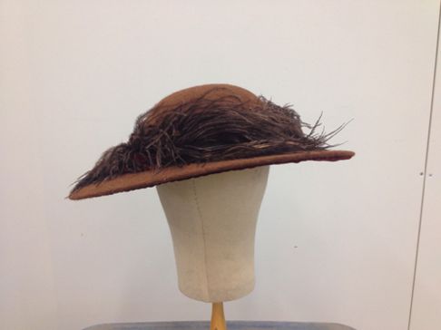 The feather completely encircles the crown of the hat.
