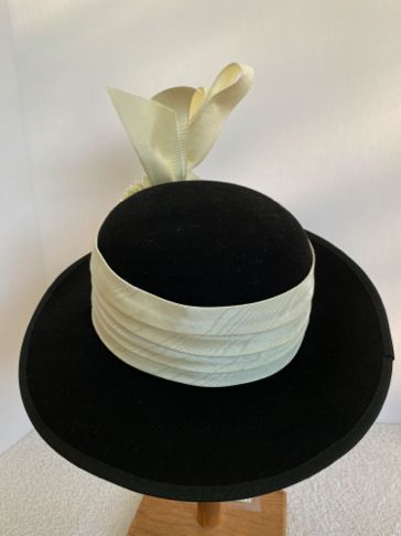 The outer edge of the brim is wired and covered with a Petersham ribbon.