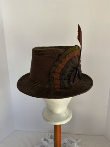 The outer edge of the brim was folded back all the way to the head fitting, and a plastic brim wire was hand stitched into the outer fold.