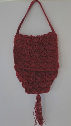 Crochet purse in red.  This one has a secret zipper compartment - not very period, but nice and secure.  Made in 2015.