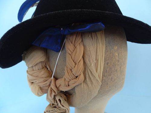 One of the blue bows peeks out from under the brim.