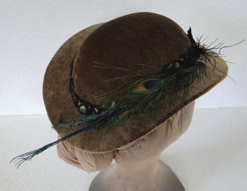 Wires and horsehair tabs allow the hat to be firmly pinned to the hairstyle, and a cord of elastic under the "bun" helps keep the hat down at the back.