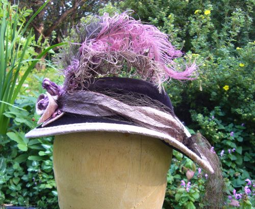 Ostrich feathers and Velvet flowers trim this round hat.