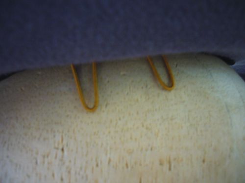 Detail of covered wire bobby-pin-places for attaching to the hair.