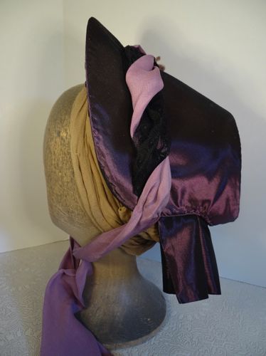 The left side of this bonnet shows the lilac chiffon and black lace the intertwine over the crown.