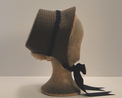 The bonnet is made of buckram and wire and covered with a houndstooth tweed that the costume designer (Chris Hargadon) chose.