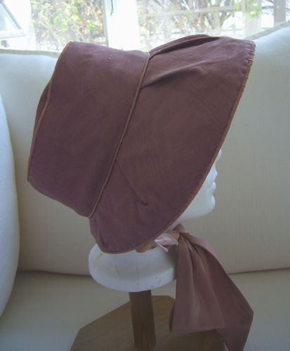 The bonnet is made from buckram and wire, and covered with moiré fabric.