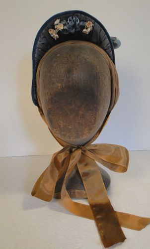 This is a modified "spoon bonnet" shape, which would have been worn fairly far back on the head.