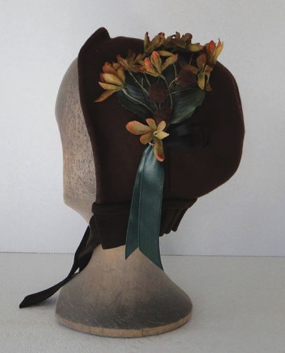 The left side was trimmed with flowers, puffs, and ribbons in warm tones with green.