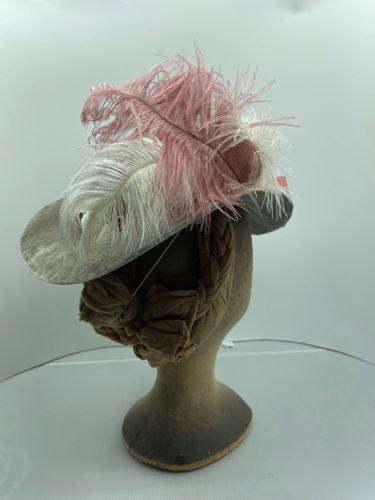 The right hand side is trimmed with pink and white ostrich feathers.