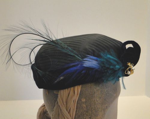 Several types of feathers were also used to trim the right side; Curled burnt pheasant, royal blue and light blue coque feathers, and a pouf of ostrich in jade green.