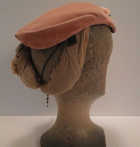 The right side of the hat remains plain.  Horse hair tabs, a wire comb, and an elastic string under the hair are used to help keep the hat on the head.