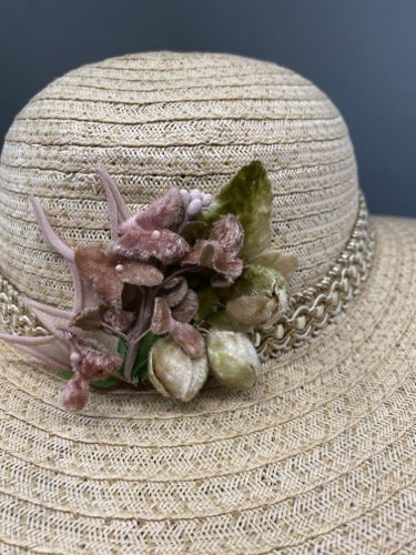 Detailed view of the smaller bouquet of millinery flowers at the front of the hat.