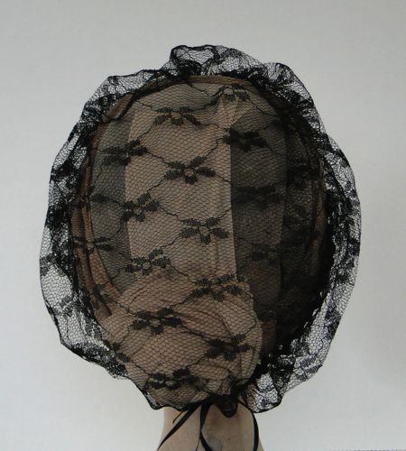 The lace is very soft and gathered under the hairstyle with a drawstring.  A comb holds the front in place.