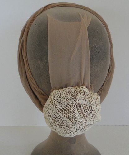 This tiny cap was made from an antique crochet doily.  Elastic was threaded along the edges.