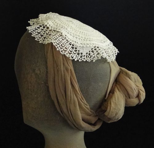 The lace has been stitched to a foundation of linen.  A wire comb is hidden at the front.