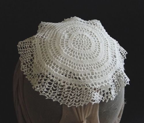 This lace cap is a style described as a "Home Cap" in Peterson's Magazine in 1857.