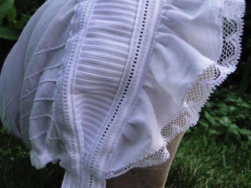 Detail of lace and pin-tucked trim, as well as fagoting trim.