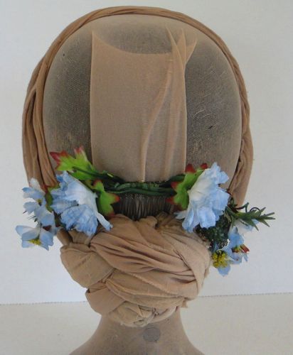 Two small bunches of blue flowers were wired together to form this evening headdress.