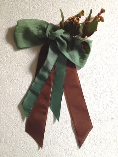This ribbon decoration was made for "Hell On Wheels" in 2014 to co-ordinate with a brown and green gown.  Three types of ribbon and a spray of tiny blooms were attached to a wire comb.