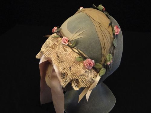 This lace cap was inspired by an illustration from Godey's Ladies Book of 1861.