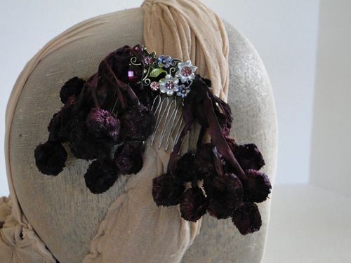 Detail view of the deep burgundy hair decoration.  A wire comb was used to keep it in place in the hair.
