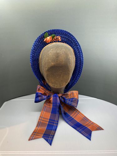 The blue and peach plaid ribbon band also forms the ties.