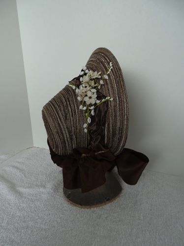 This side view shows the overall effect of the flowers on the outside.  Beneath the flowers is a twisted brown taffeta ribbon, 2" wide.