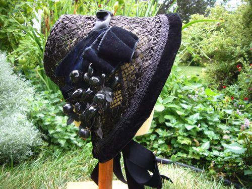 Straw bonnet made for “Hell On Wheels” 2012, the straw was dyed black before trimming with large berries & velvet.