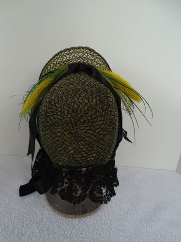 Back view of the lacy straw bonnet shows the symmetrical arrangement of the decoration.