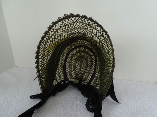 Lacy straw bonnets were worn in the summer, in the first half of the 1860's.  They allowed the breezes through, but kept the sun out of a lady's eyes.