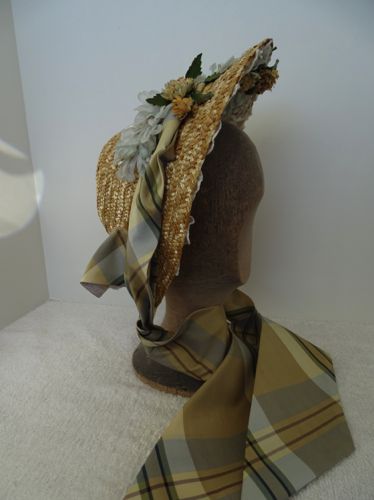 Made in 2018 of re-claimed straw, this spoon bonnet is trimmed with plaid taffeta cut on the bias making band and the ties.