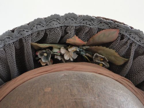 The inside of the brim was trimmed with grey net, grey lace, and hand-tinted greenish grey forget-me-nots, plus greyish green rose leaves.