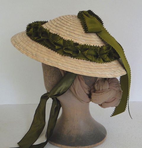 The crown is trimmed with a green picot edged ribbon that has been double pleated. A bow is placed at the top with streamers at the back. In profile you can see that this hat is not very large.